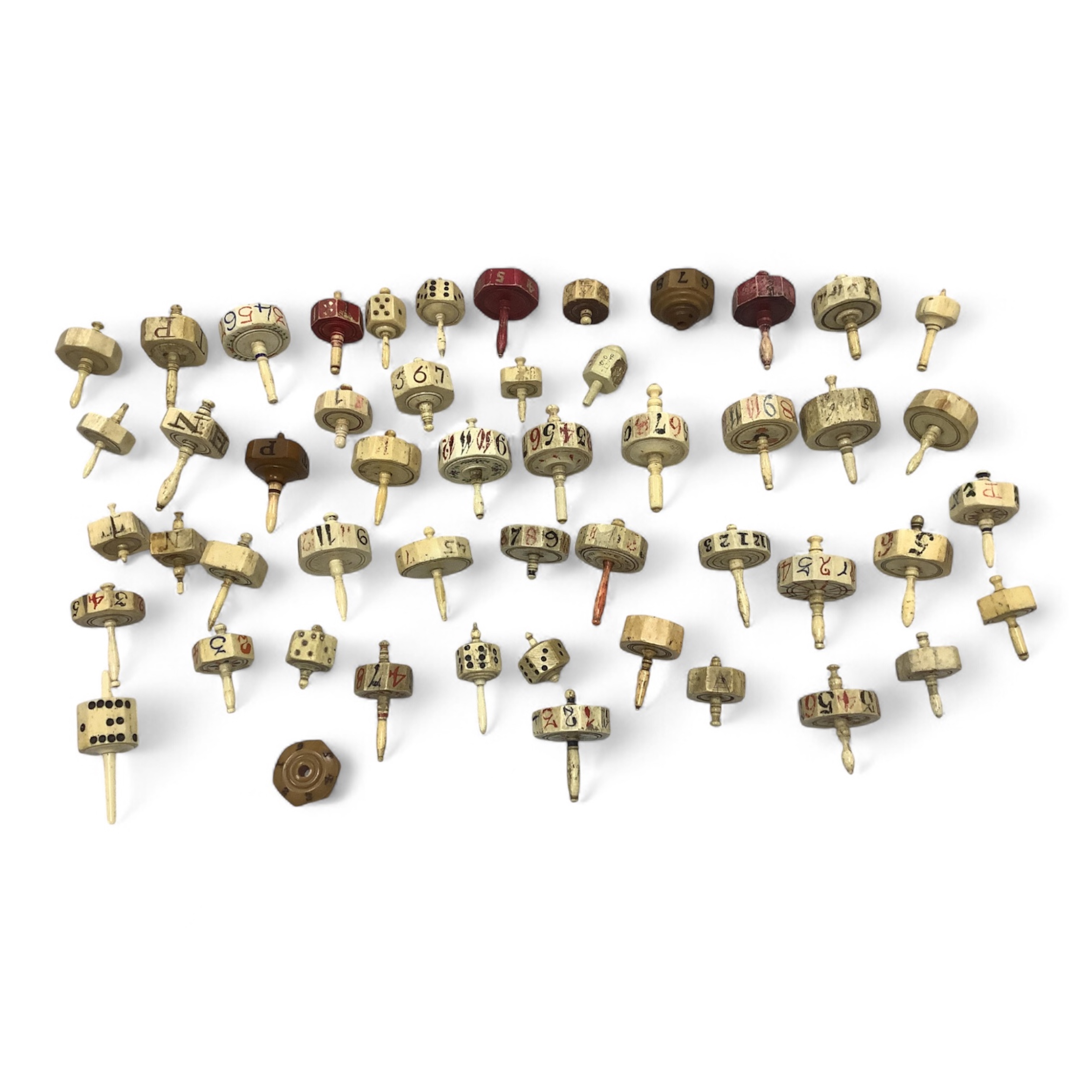 A collection of 19th century bone or coquille nut teetotum gaming spinners or twirlers and gaming items, in a leather box